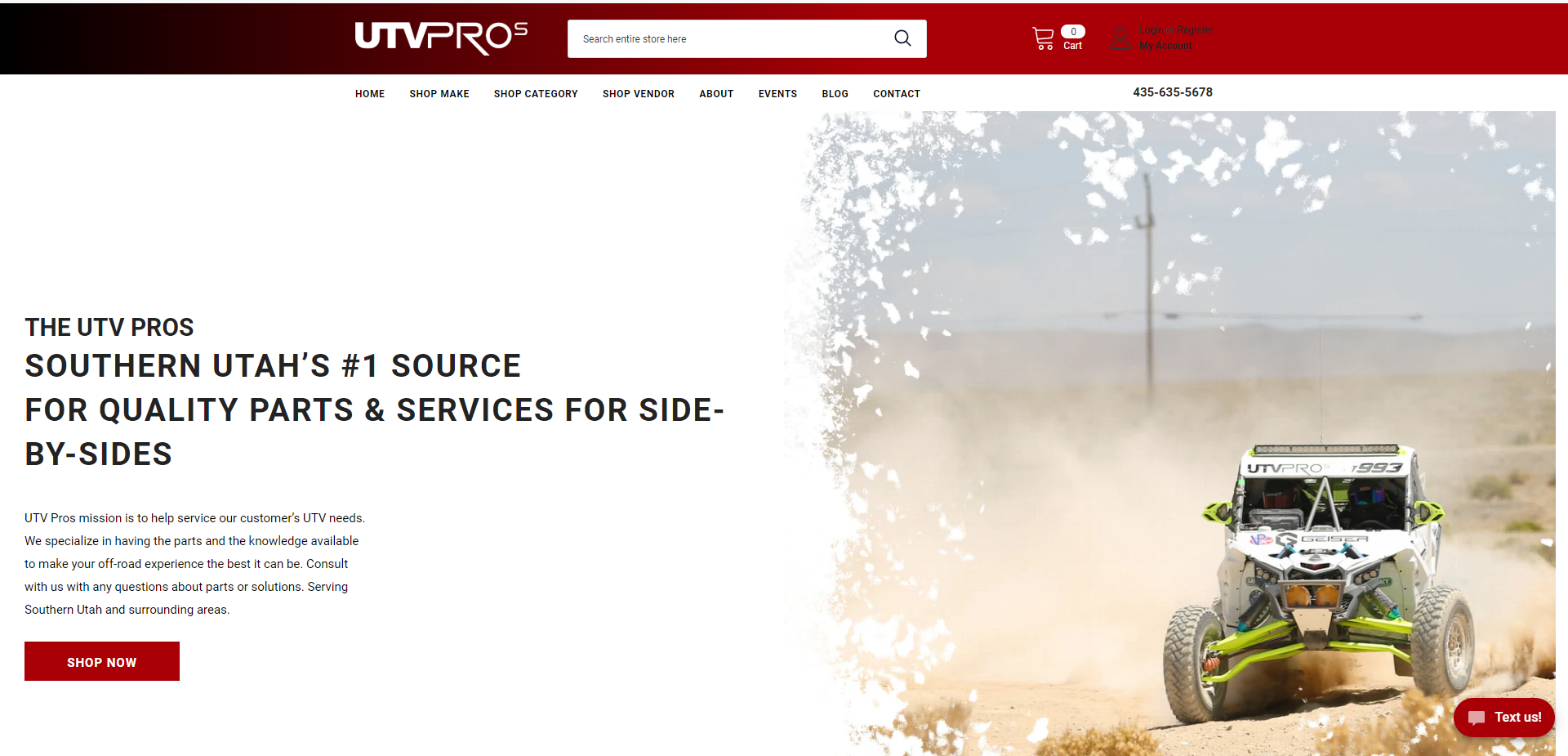 Off-road vehicle racing in dusty desert landscape.