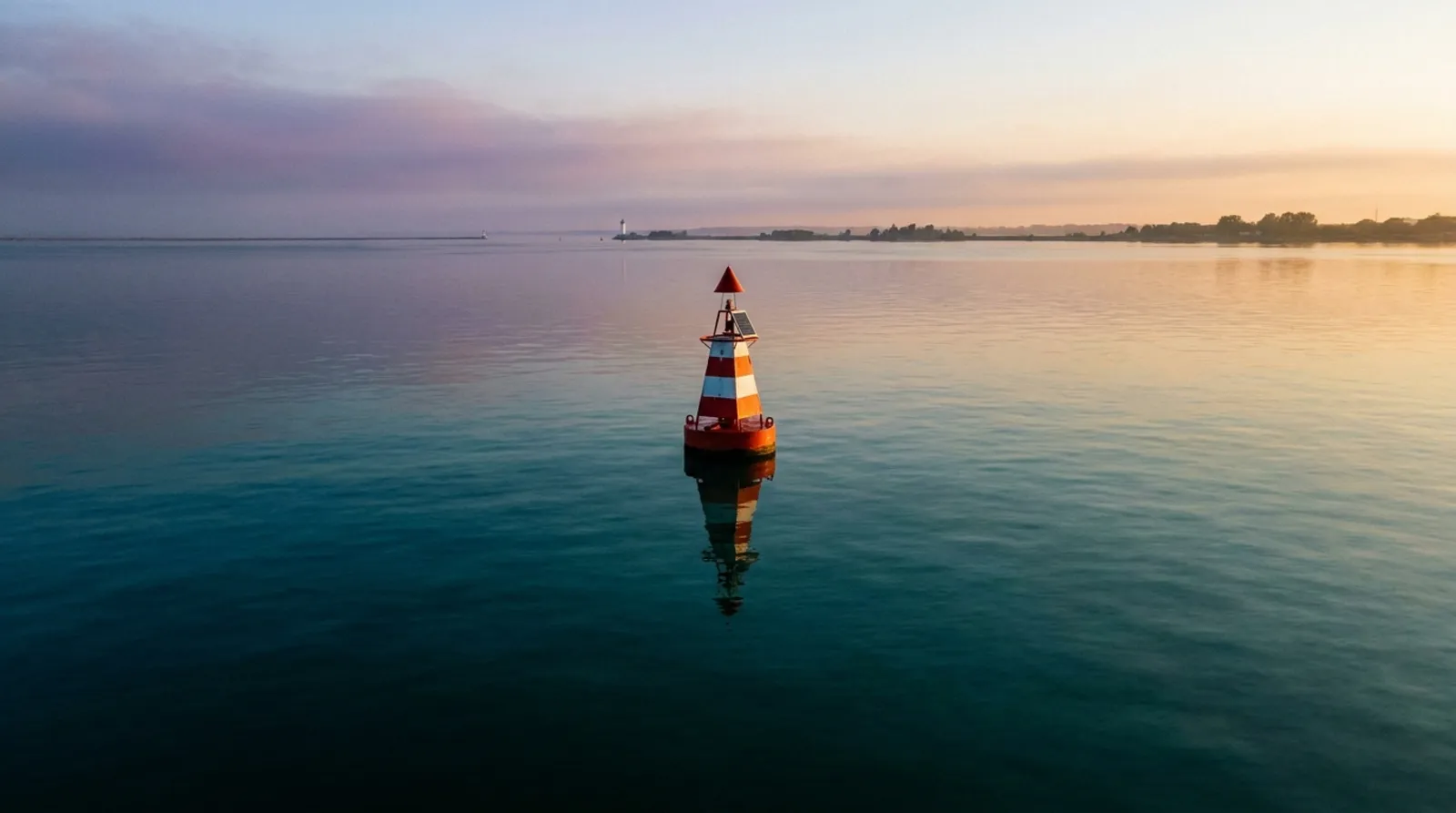 A channel marker buoy standing in calm harbour water